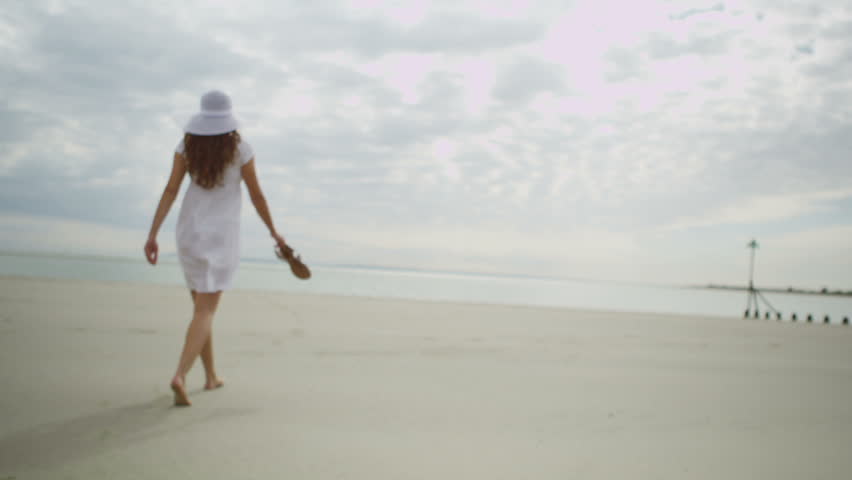 Girl in a white dress walking on the beach images Girl in a white dress walking on the beach images