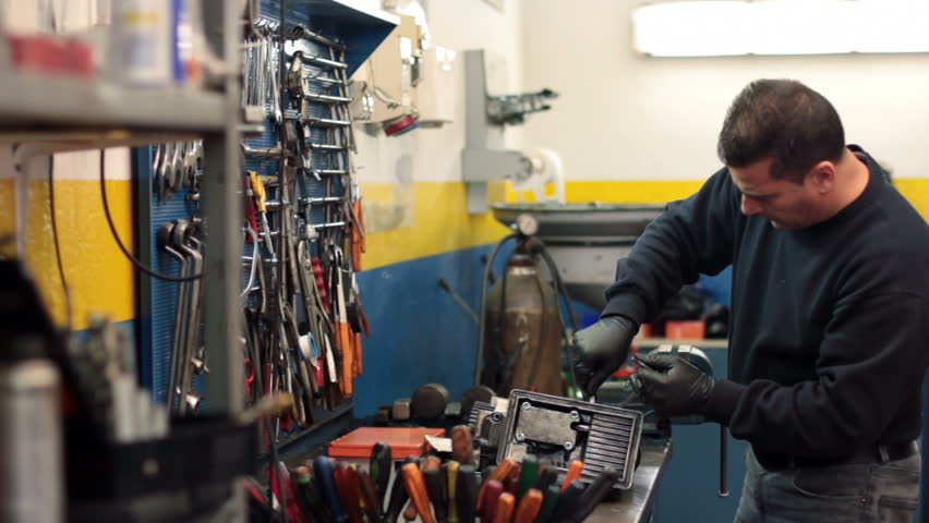 Auto mechanic repairs a motor