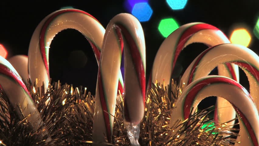 Candy canes rotating in holiday scene. (HD)