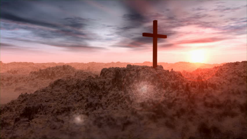 Pan of Cross in desert landscape at sunrise