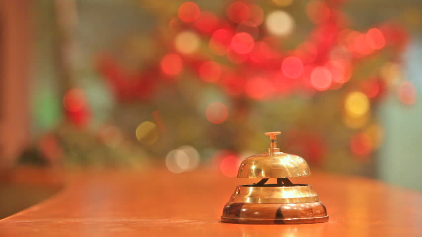 old hotel bell on a wood stand with two calls