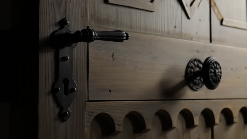 Static shot of an antique wooden door not color graded