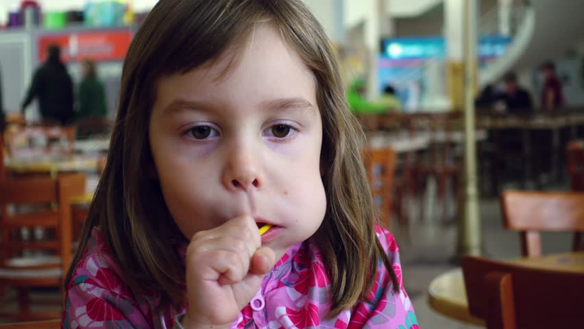 Little Girl Sucks Lollipop