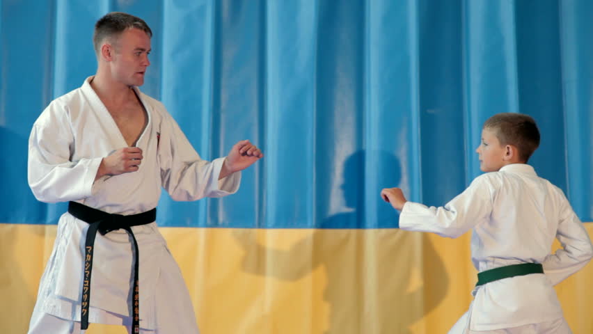 Boy learning from his karate instructor