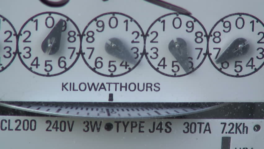 Macro view of a fast moving electric meter showing wasted energy