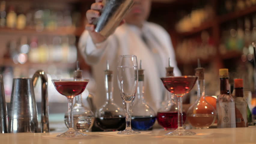 A series of model released clips featuring a female cocktail waiter in a classic looking cocktail bar in barcelona, Spain