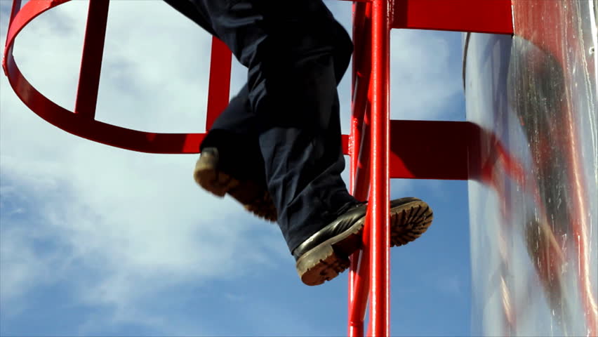 Worker climbs up on the silo