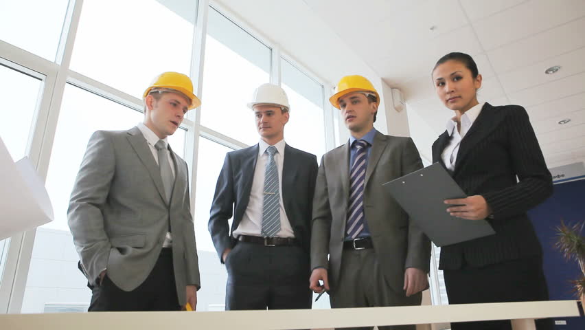 Businesswoman brings project to architects to discuss it 