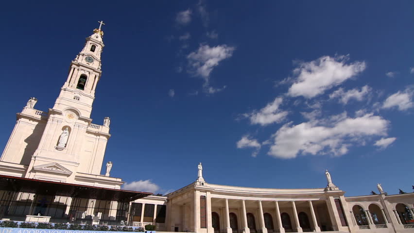 Basilic of Our Lady of the Rosary against a blue sky with moving clouds 