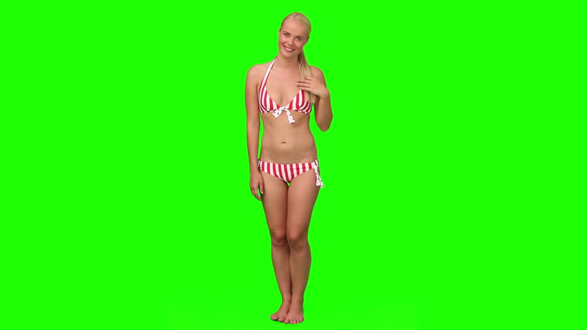 Chromakey footage of a cute blond woman in swimsuit looking at the camera