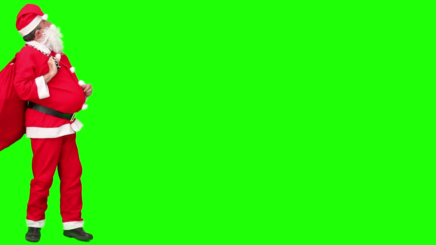Santa Claus with his bag of gifts against a green screen