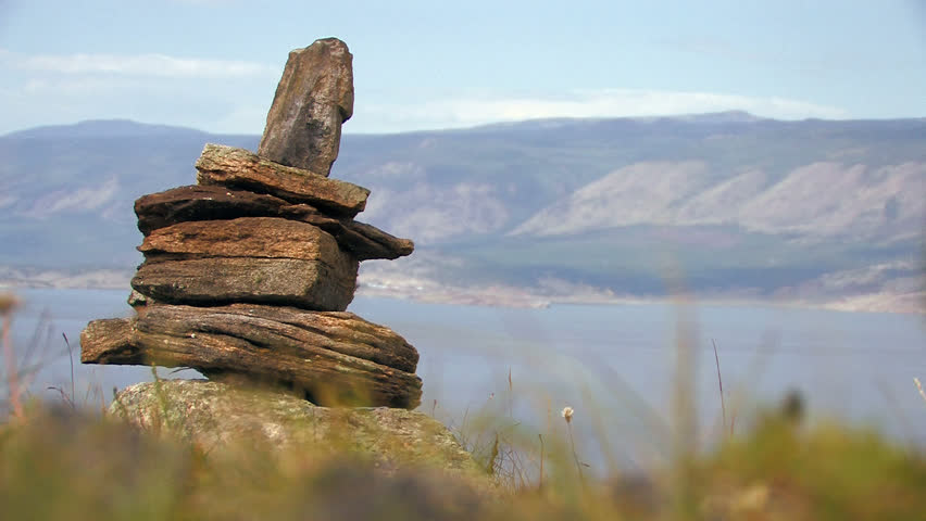 HD. Stone beacon of shamans on coastal mountain