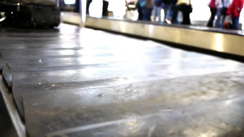 baggage belt is moving and a case passes