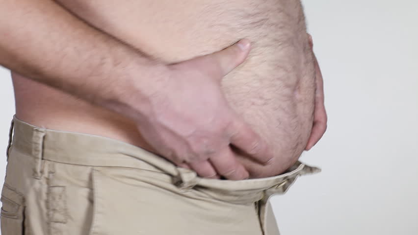 Fat man grabbing his big belly