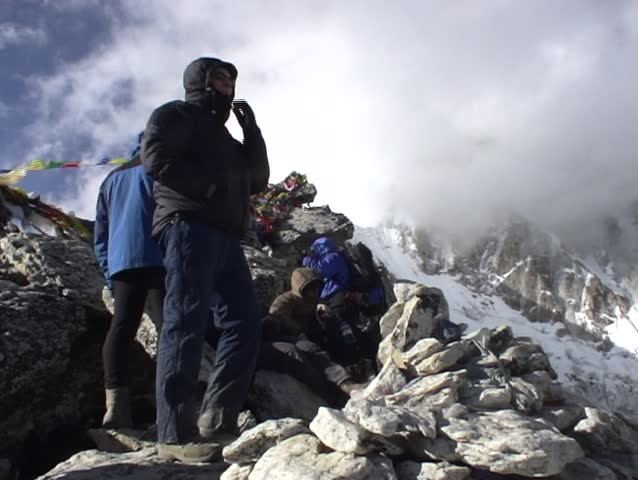 Panning shot of tourists and Mount Everest, from Kala Patar, Nepal.