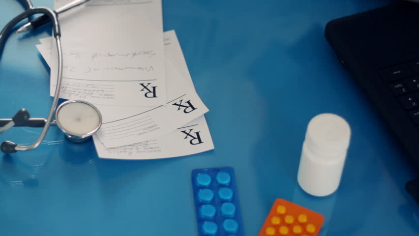 Male doctor hands taking pill from the bottle