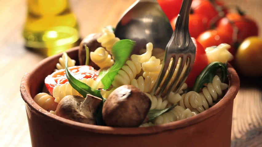 mixing pasta salad