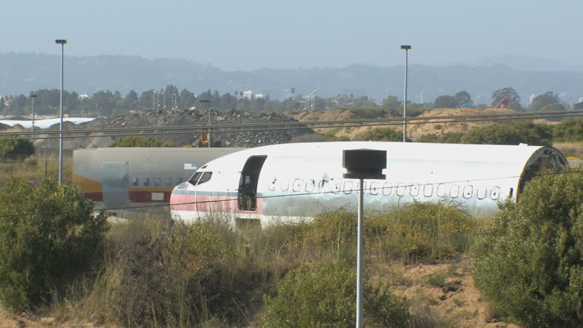 This is a long shot of two airplanes sitting in the California sun rusting and rotting. They look like they were dismantled decades ago.