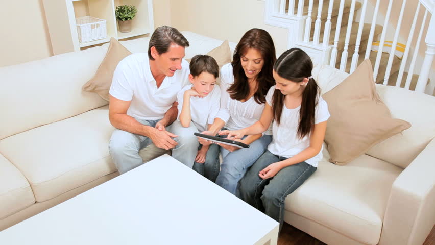 Attractive caucasian family using a wireless tablet & giving each other a high five