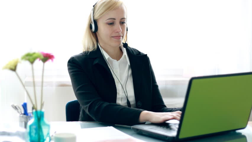 Attractive helpdesk consultant smiling to the camera