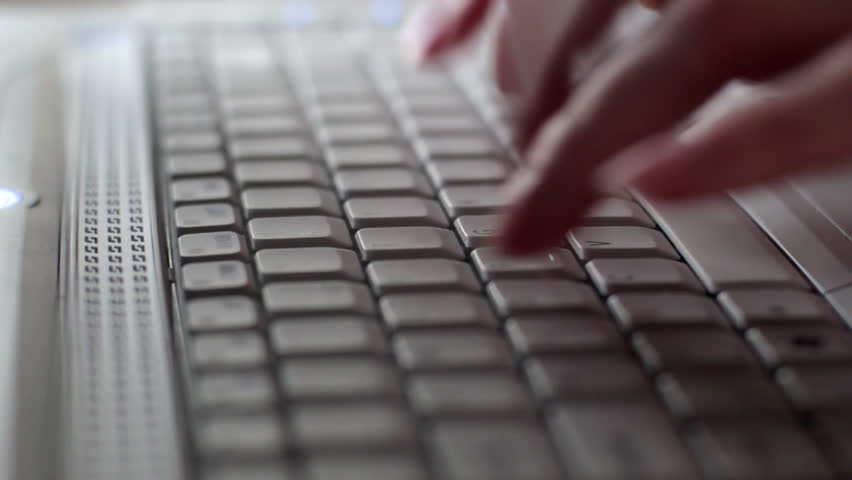 Tracking shot of woman using laptop