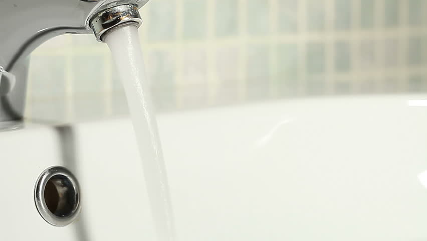 Water running in white faucet