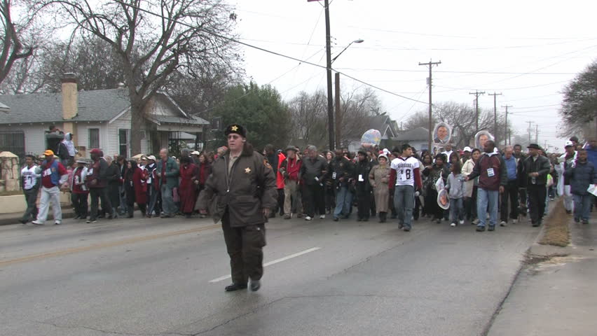 Video of the largest Martin Luther King MLK March in the USA in San Antonio, Texas. Multi ethnic people marching in support of equal rights. Misty rainy day in January. Editorial. 