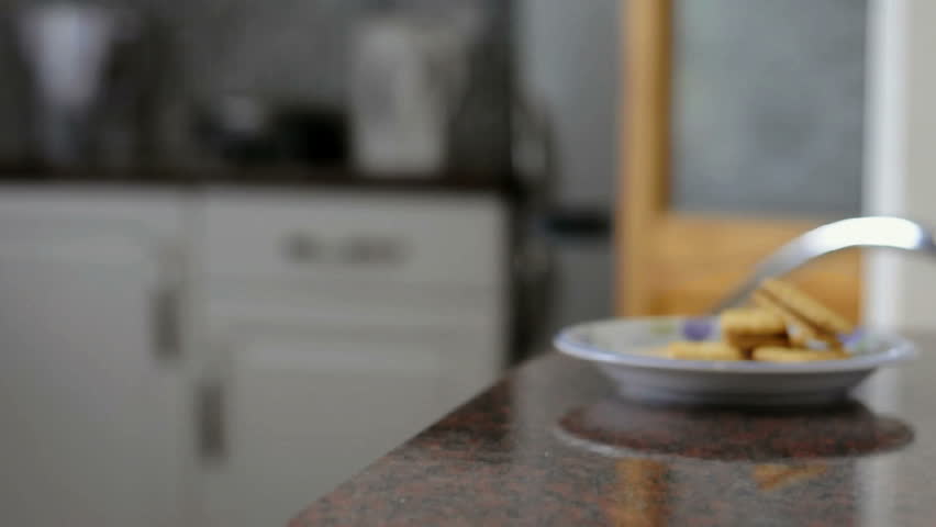 Steaming white mug with man reading newspaper at the background.