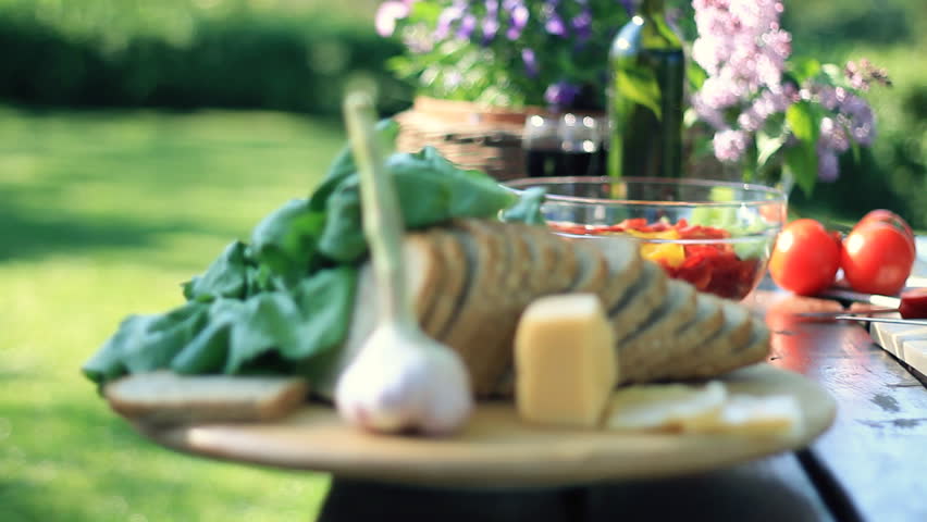 Dolly shot of table full of food in the garden
