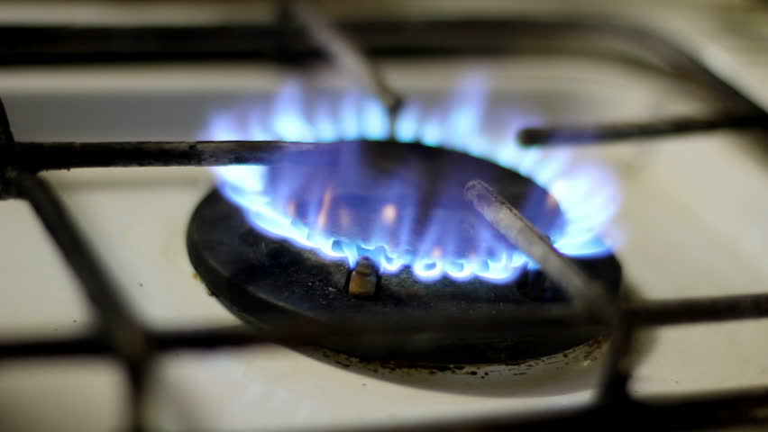 Rustic stove burner. Flames close-up.