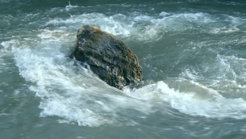 Blue water of the stream washes the lone stone, gathering and foaming, continues to flow on. 