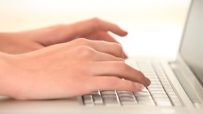 Hands typing on a keyboard