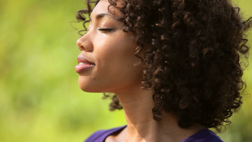 Young woman smiling in sunlight
