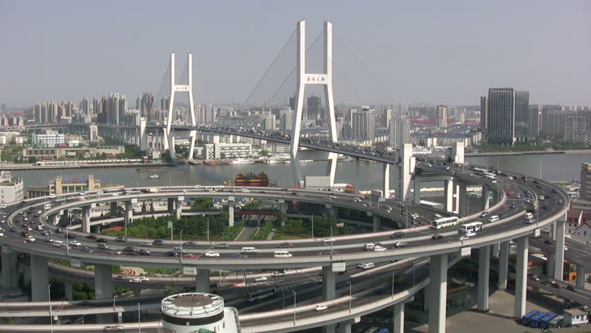 Nanpu bridge in Shanghai shows a massive roundabout, bridge, and heavy traffic.