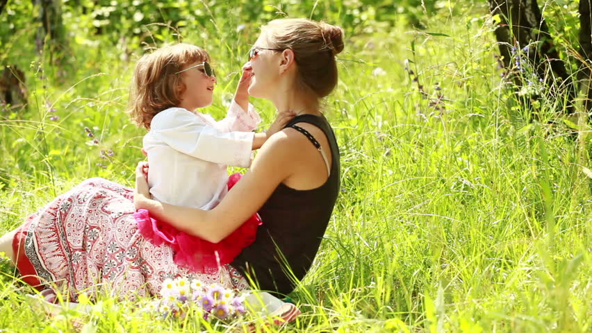 Mother and baby in sunglasses. They laugh. 