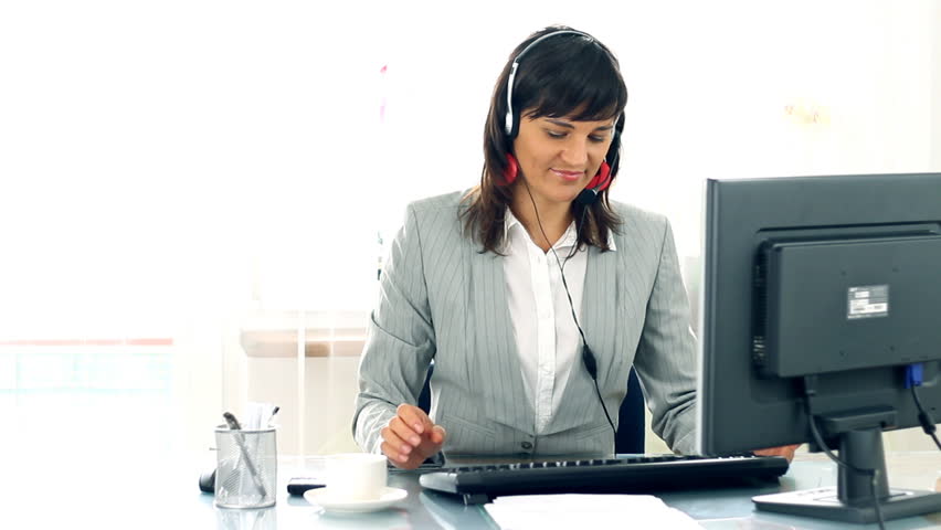 Attractive helpdesk consultant smiling to the camera
