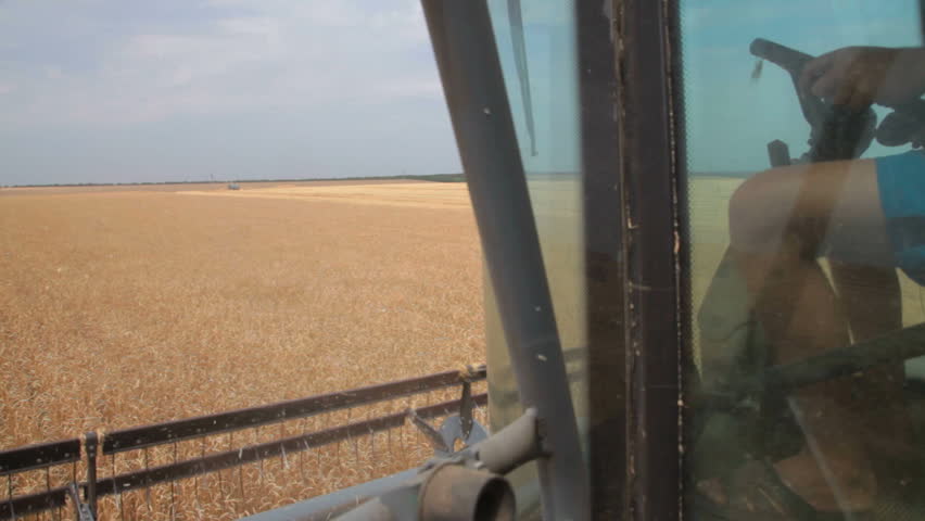 farmer driving a combine harvester