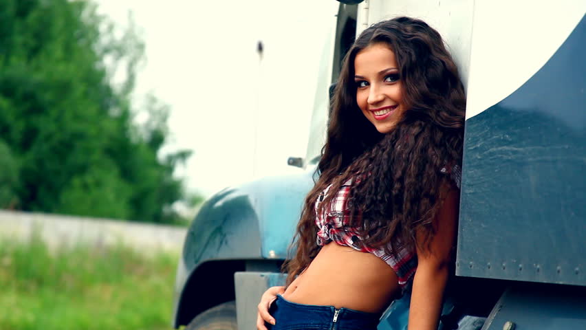 Young beautiful girl and lorry truck in summer