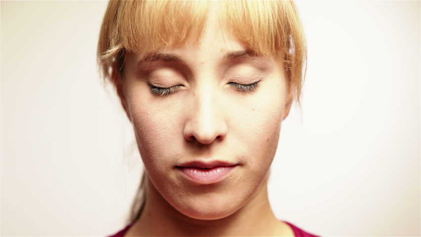 Young attractive woman opening and closing her eyes