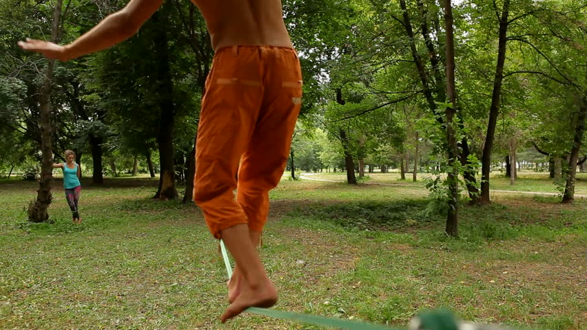 guy walks on slackline