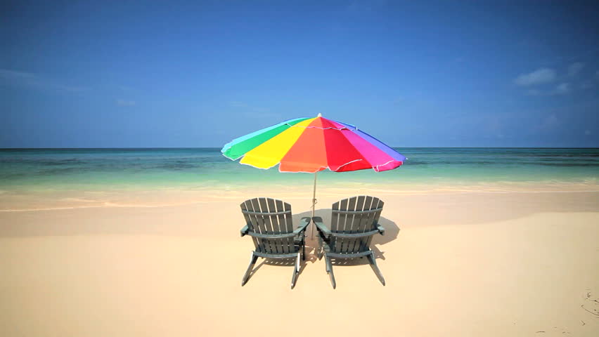 Sun parasol & easy chairs inviting you to relax on a peaceful sandy beach