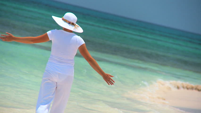 Elegant young female reveling in achieving her fantasy of a luxury island vacation
