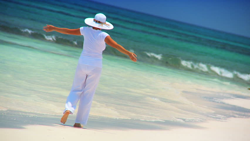 Elegant young female reveling in achieving her fantasy of a luxury island vacation