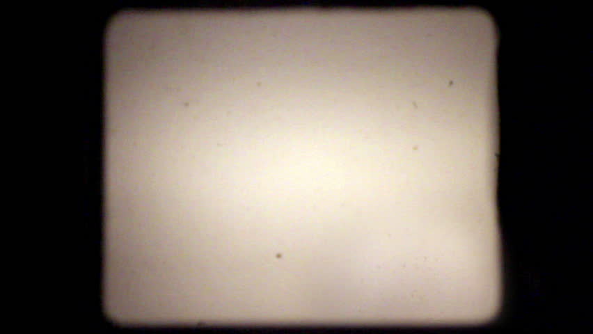 30 seconds of dust, hair, and scratches, lifted from real 8mm film, with film projector audio. Composite this over your footage to get a retro film look. 