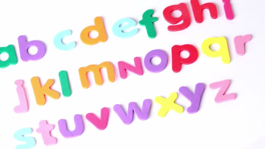 Multicolored letters laid in three rows in alphabetical order, composition rotates