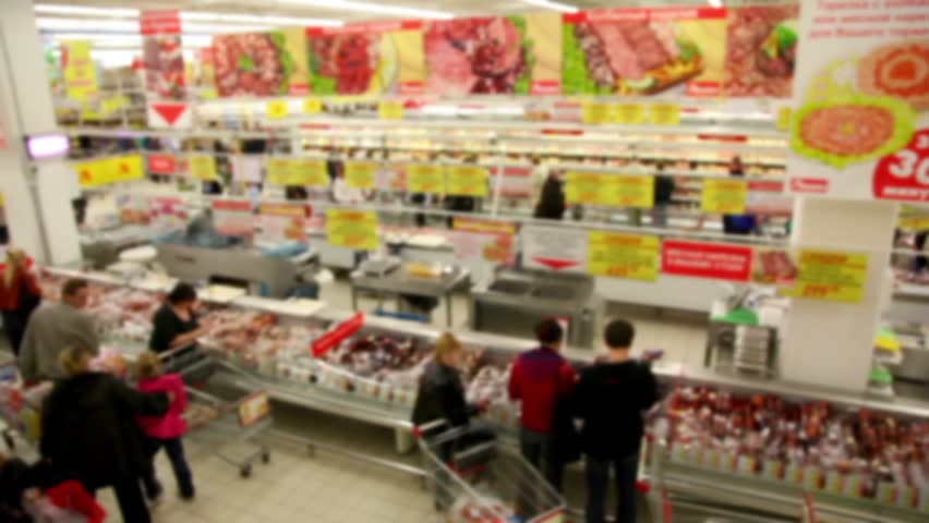 People make purchases at the store, the camera moves along the supermarket 