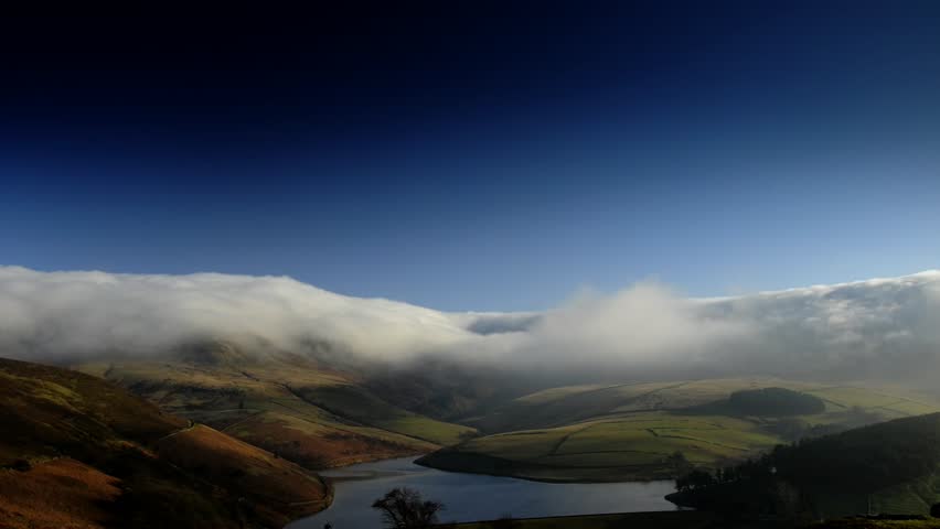 Dramatic time lapse of clouds moving through a mountain pass landscape