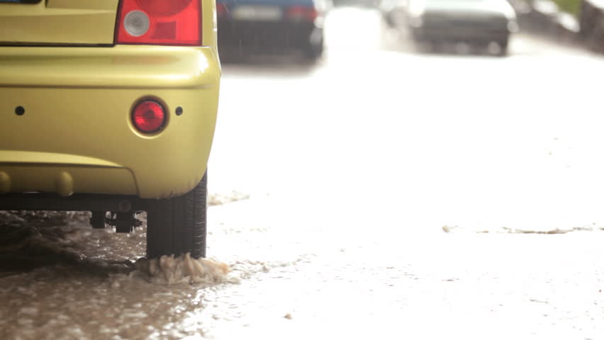 car in a stream of of rainwater