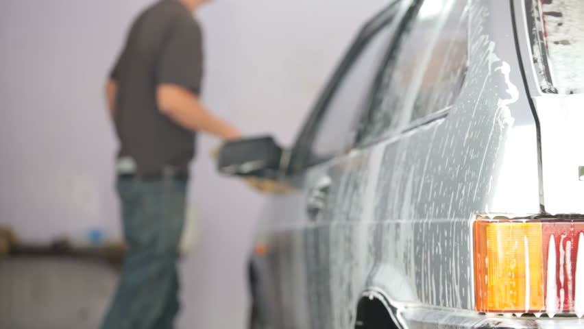 Unrecognizable Manual Worker  washing car