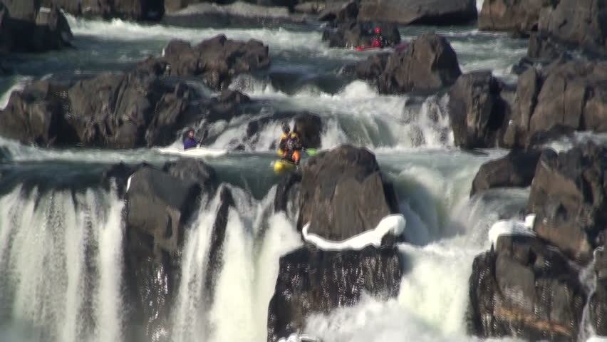 A kayaker plunges off a rapid 